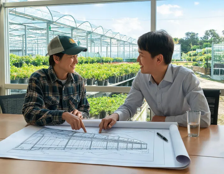 A grower and buyer reviewing covering dimensions